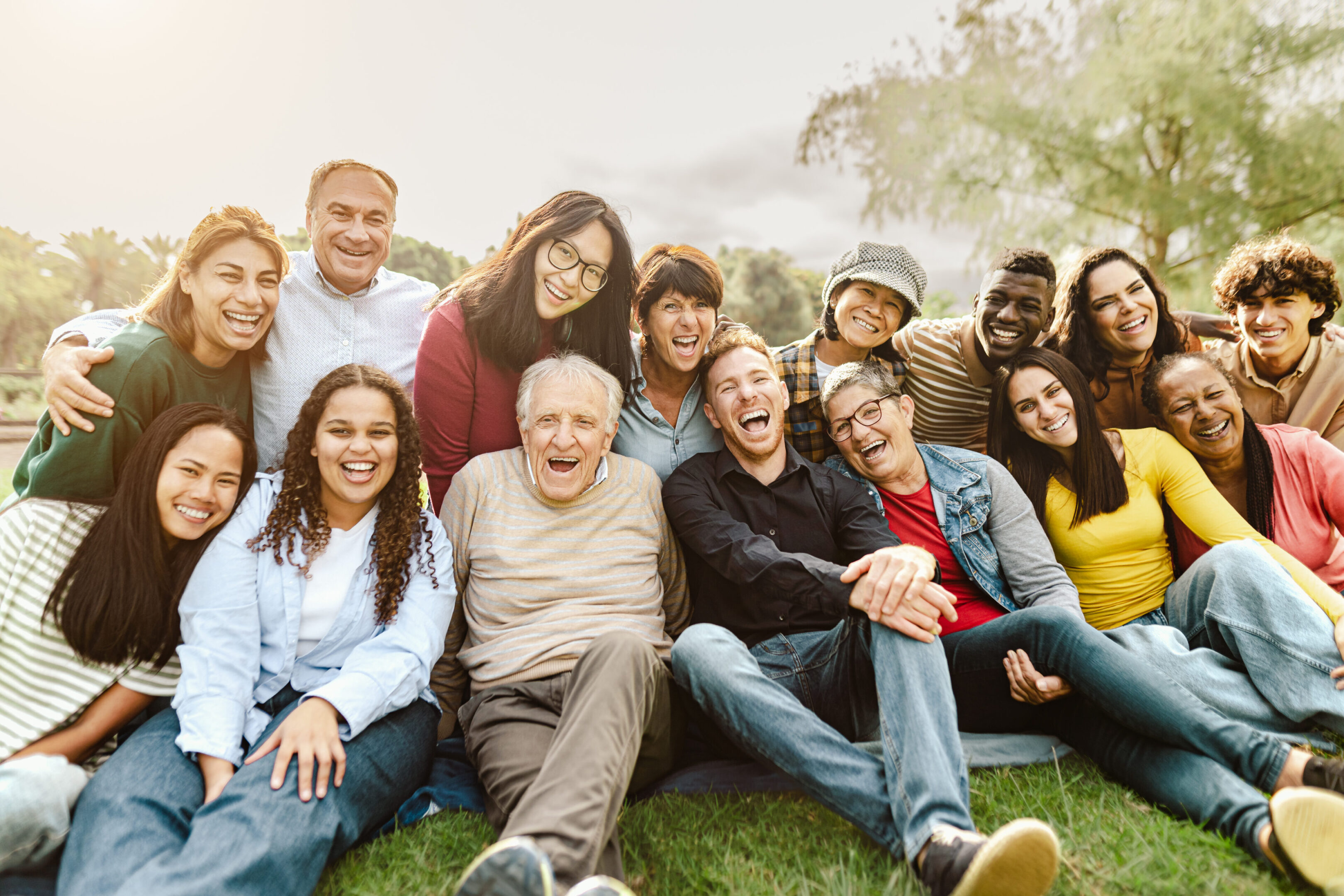 Diverse group of people smiling outdoors.