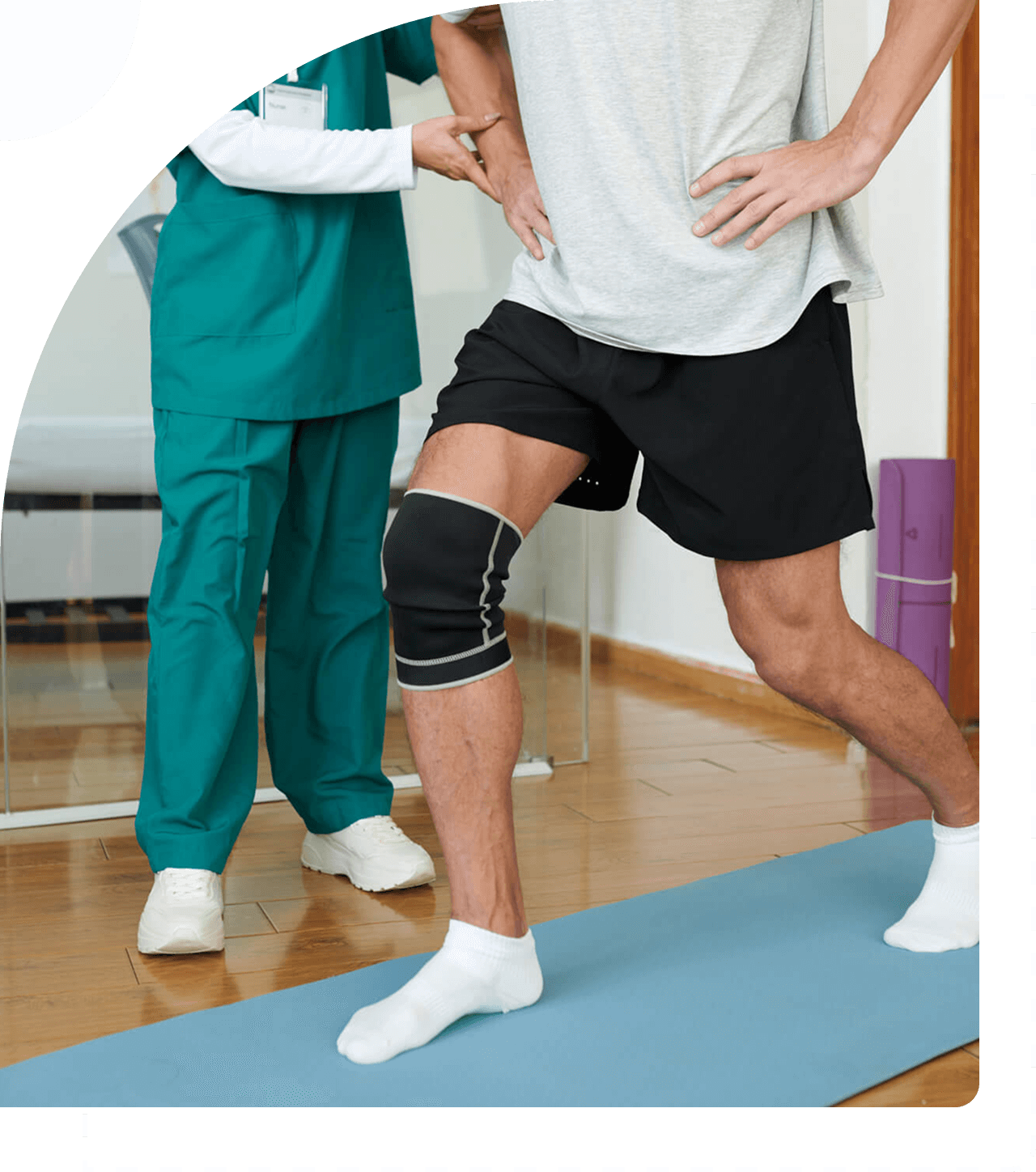 Man exercising with knee brace and trainer.