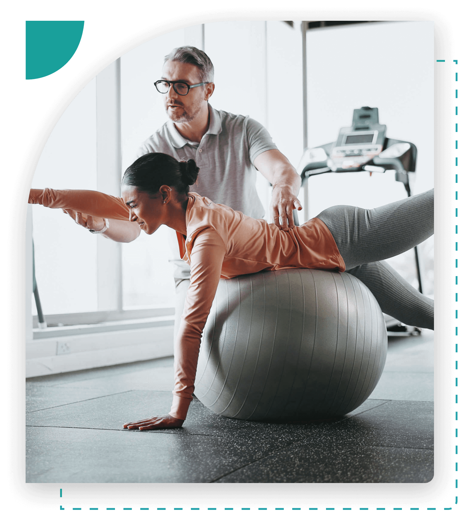 Woman exercising with trainer on stability ball.